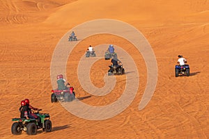 Quad Biking Dubai Adventure Tour Ã¢â¬âTourists having fun on Quad Bike Riding in dunes of Dubai.